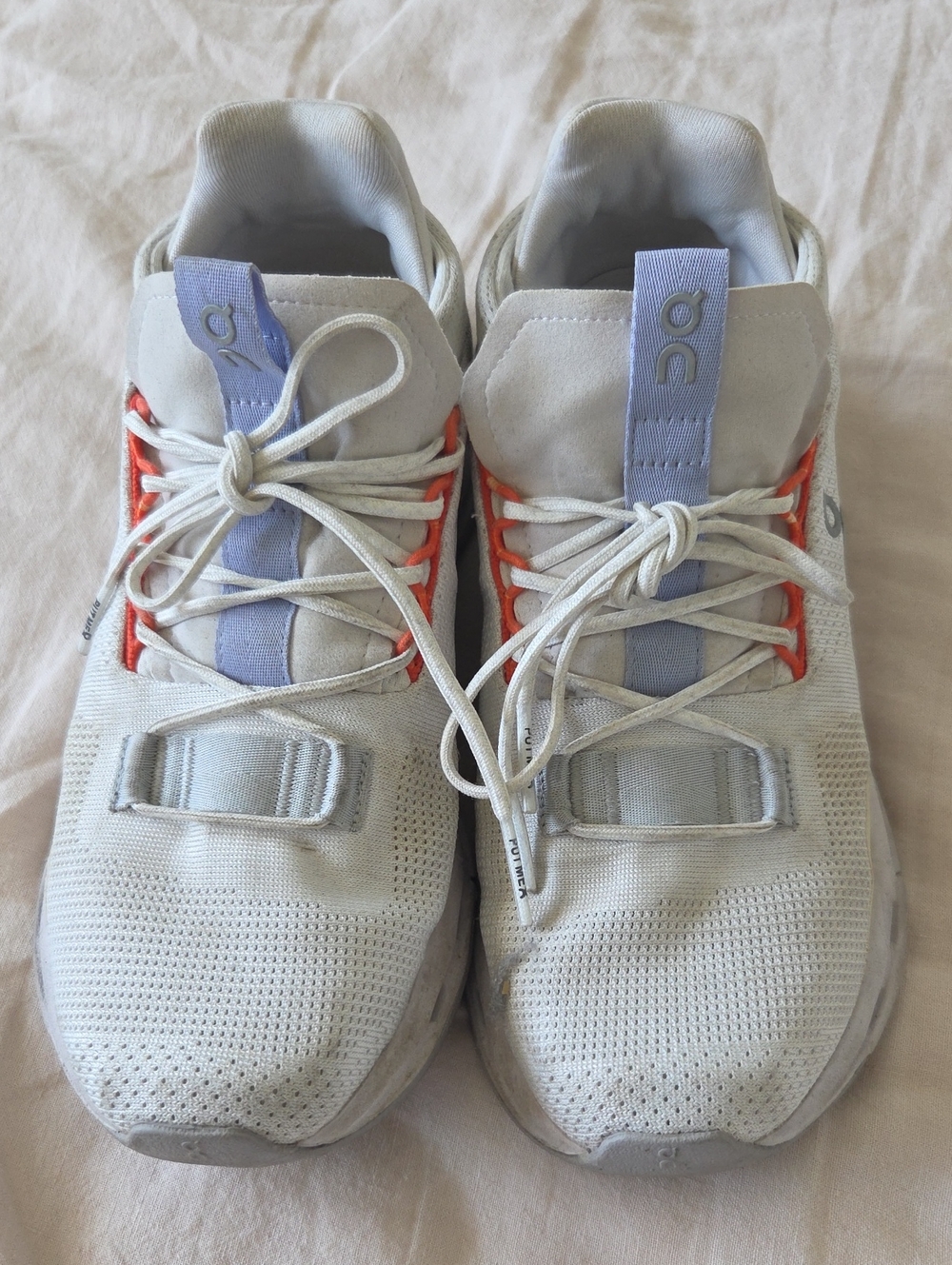On Running White Athletic Sneakers with Lavender Pull Tabs and Orange Eyelets